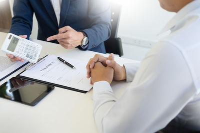 Midsection of man using mobile phone