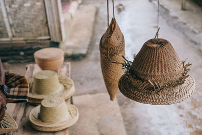 Close-up of wicker hat hanging for sale at market