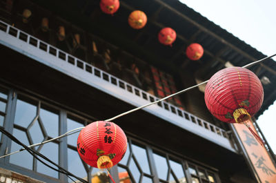 Low angle view of illuminated lanterns hanging in row