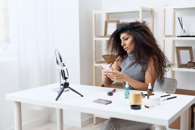 Portrait of young woman working at home