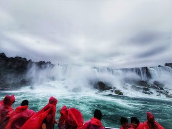 Scenic view of waterfall against sky