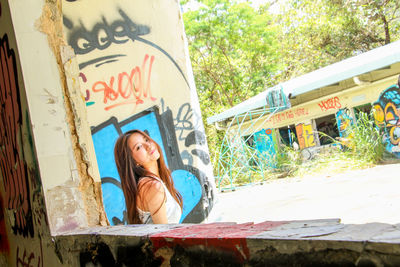 Close-up of young woman against tree