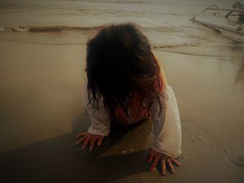 High angle view of woman sitting at beach