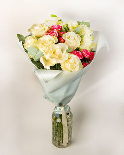 Close-up of rose bouquet on white table