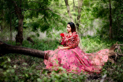 Portrait of woman sitting in a forest