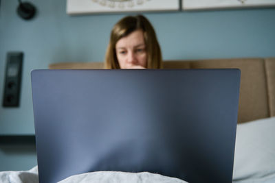 Young woman using laptop at home