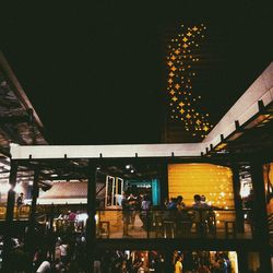 People in illuminated city at night