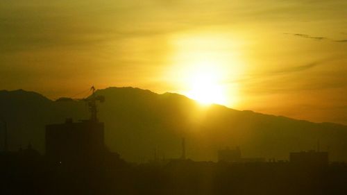 Scenic view of mountains against sky at sunset