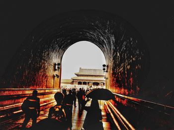 People in tunnel against clear sky