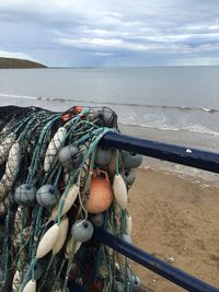 High angle view of tackle and net by sea against sky