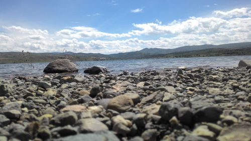 Rocks on beach against sky