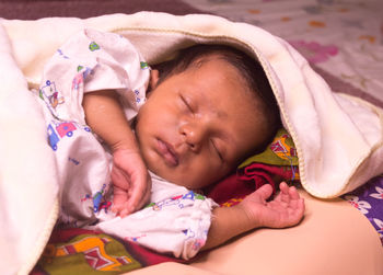 Cute baby sleeping on bed