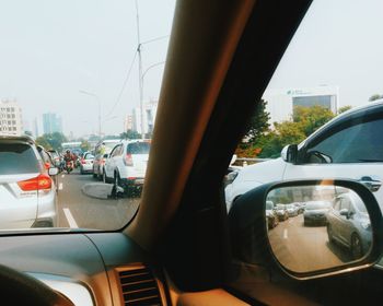 Vehicles on road seen through car window