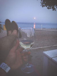 View of drinking glass on table at beach