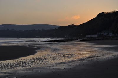 Scenic view of beach against sky during sunset