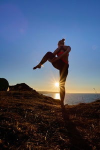 Full length of man standing on beach against sky