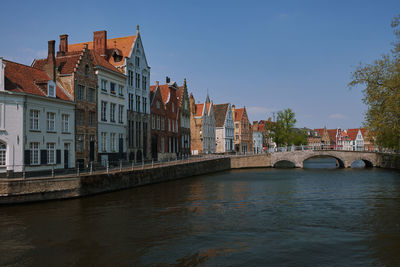 Bridge over river in city, brugge, belgium