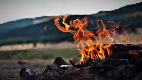 Close-up of bonfire against mountain