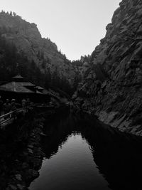 Scenic view of lake by tree mountains against sky