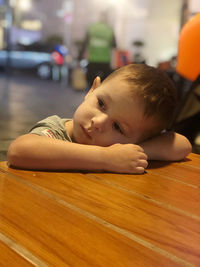 Cute boy leaning on table