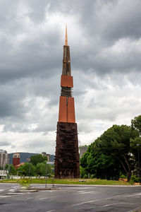 View of tower of building against cloudy sky