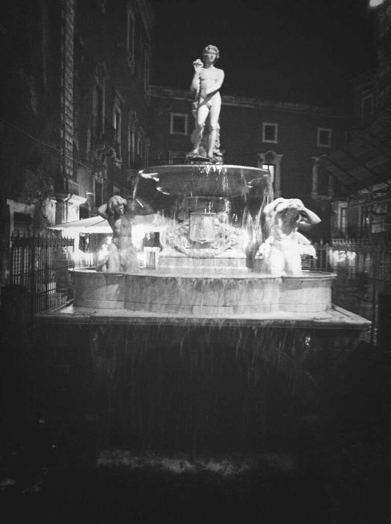 statue, sculpture, water, fountain, building exterior, human representation, architecture, built structure, art and craft, art, creativity, spraying, animal representation, motion, night, city, splashing, waterfront