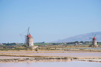 Traditional windmill on field against sky