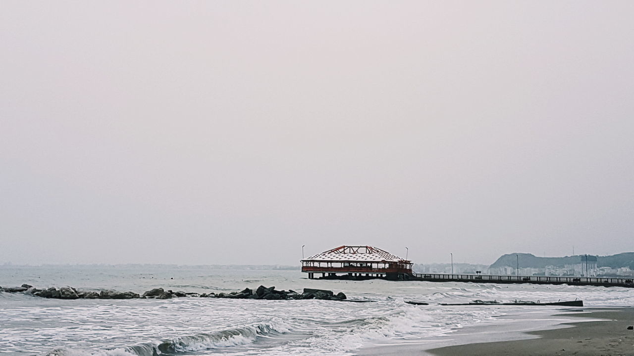 copy space, sea, clear sky, water, nature, architecture, built structure, waterfront, outdoors, day, scenics, tranquility, no people, beauty in nature, sky, horizon over water, nautical vessel