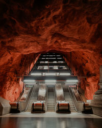 Escalator in underground cave of metro station.