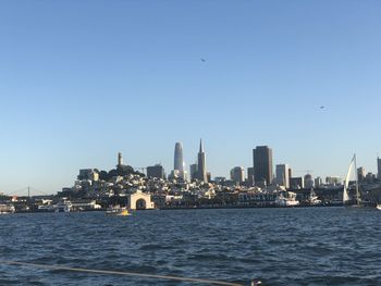 View of city buildings against clear sky