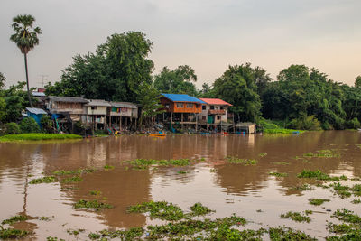 Scenic view of lake by building against sky