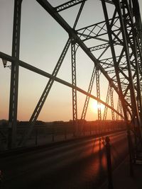 Silhouette bridge against sky during sunset