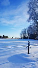 Water pump on snow covered field against sky