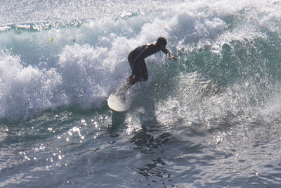 Full length of man surfing in sea