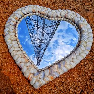 Low angle view of heart shape against sky