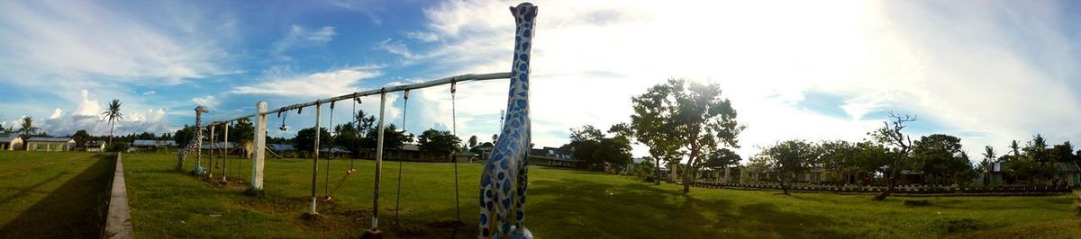Panoramic view of field against sky