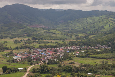 High angle view of agricultural field by buildings