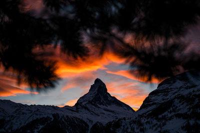 Scenic view of snowcapped mountains against sky during sunset