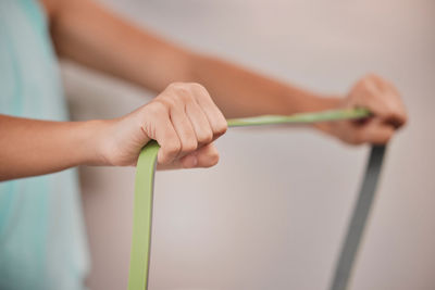 Midsection of woman holding tape measure