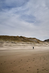 Man on beach against sky