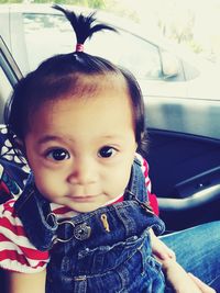 Portrait of cute girl sitting in car