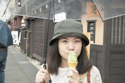 Portrait of young woman eating ice cream