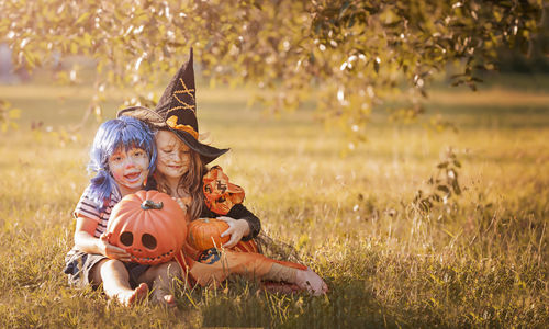 Boy and girl in carnival costumes celebrate halloween