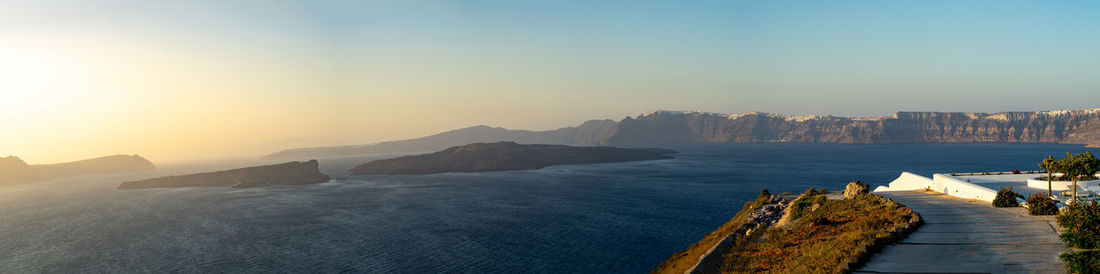 Beautiful panoramic view from akrotiri to caldera and volcano at golden hour. santorini island.
