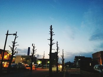 Cars on road in city against clear sky