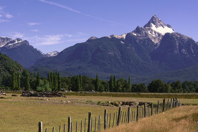 Scenic view of field and mountains against sky