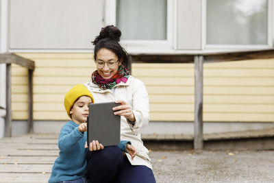 Woman with child using digital tablet