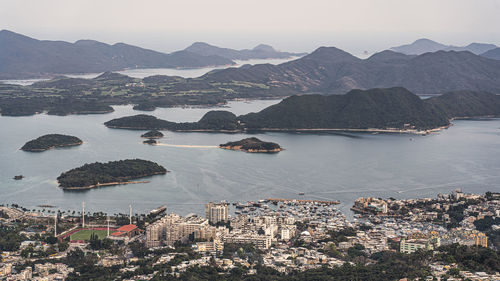 High angle view of bay and cityscape against sky