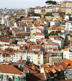 High angle view of houses in town against sky