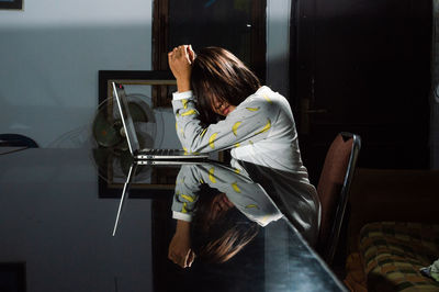 Woman sitting on table